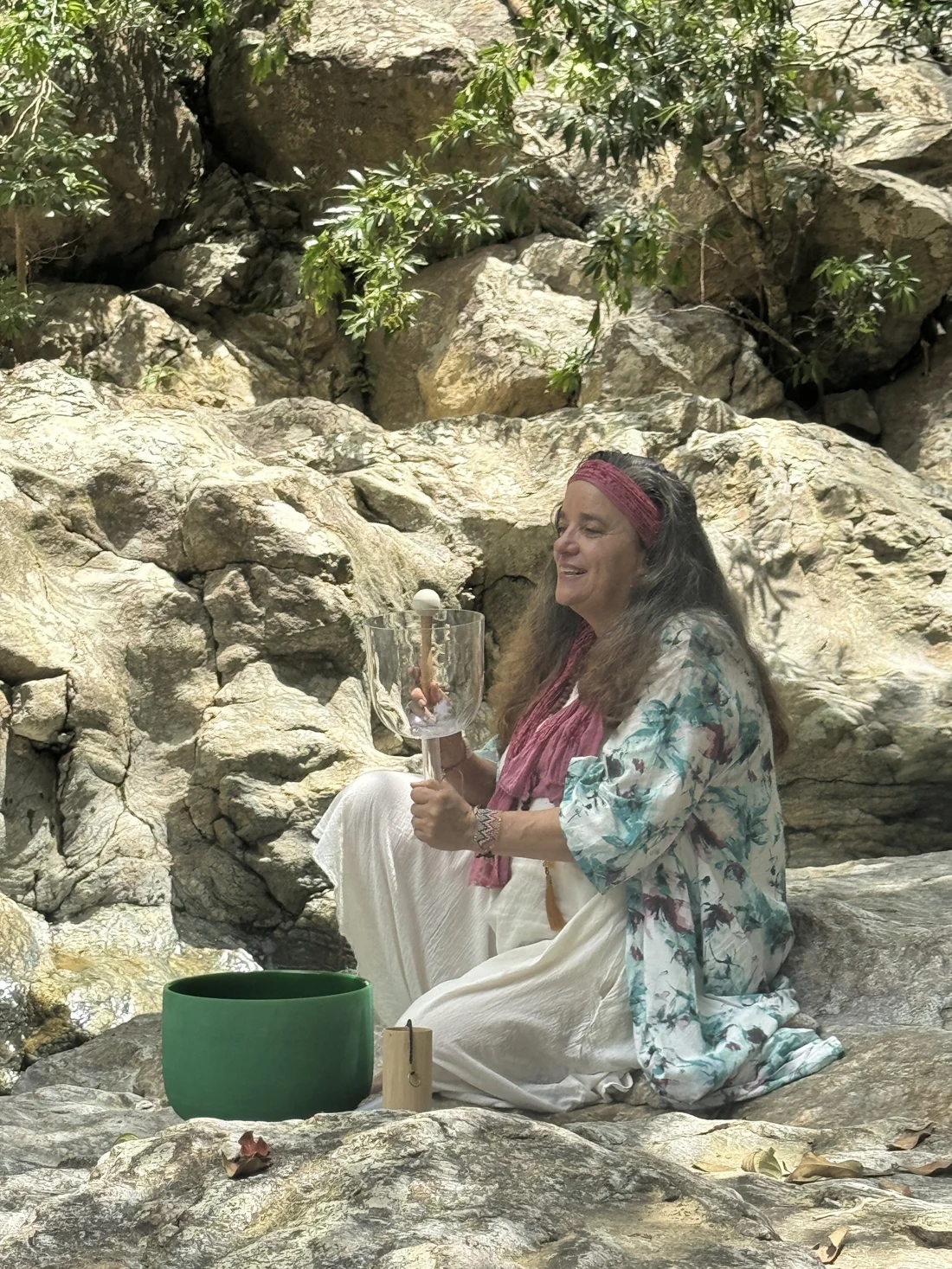 Claudia practicing outdoors with crystal singing bowls